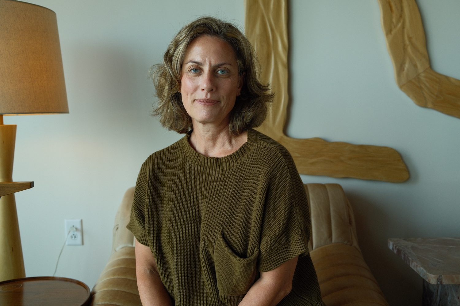 Ann Hatcher smiling in a cozy living room.