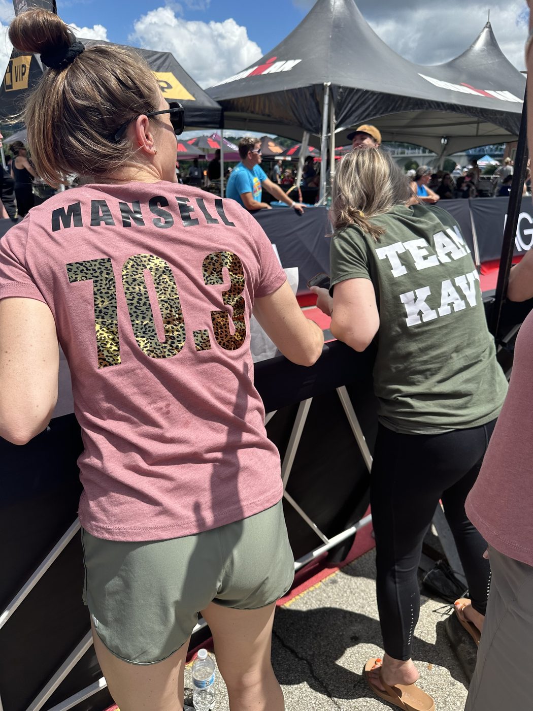 The back of Jess Mansell's race shirt reading "Mansell 70.3" at an Ironman triathlon.